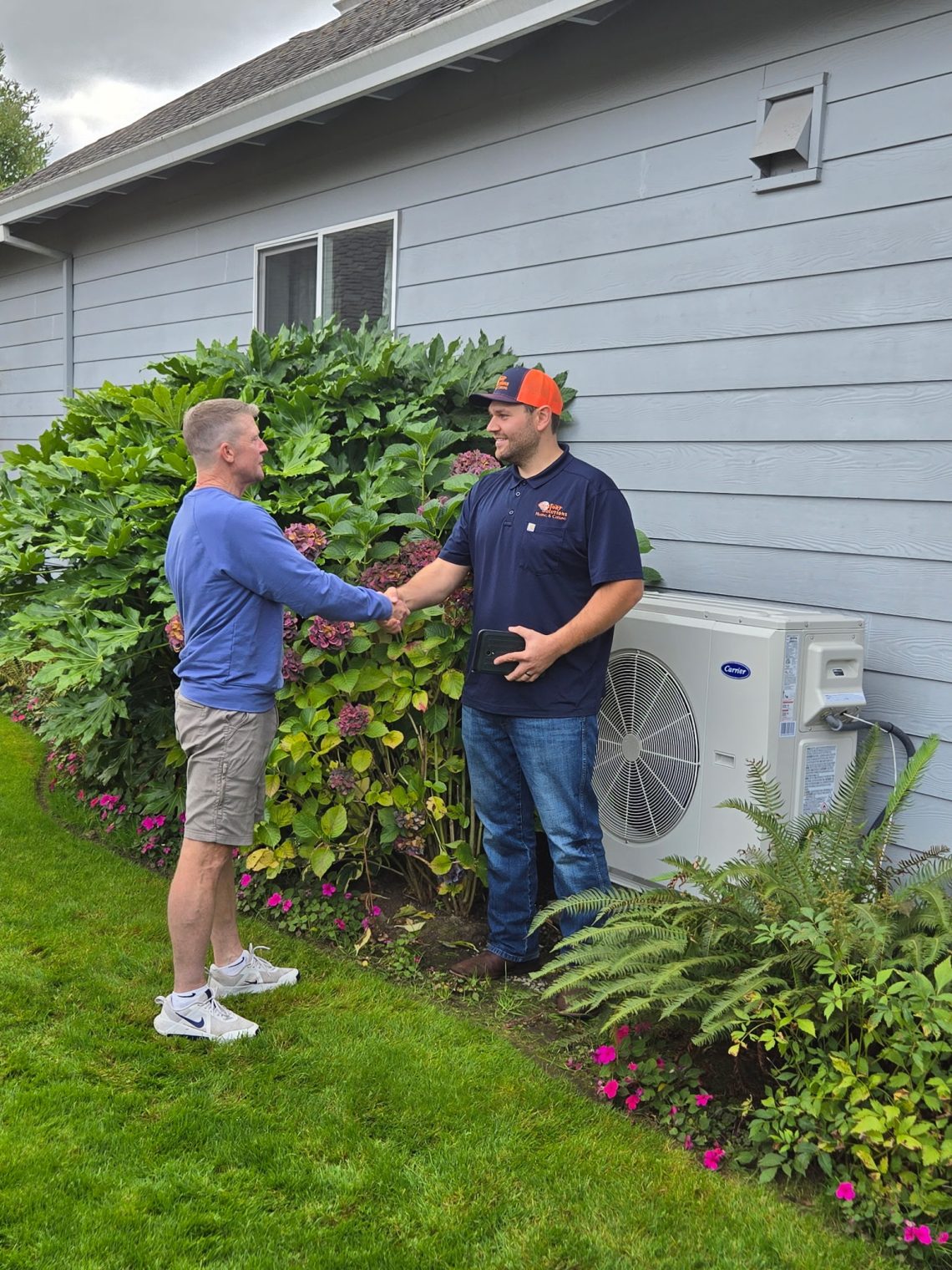 Service repair man shaking hands with a customer.