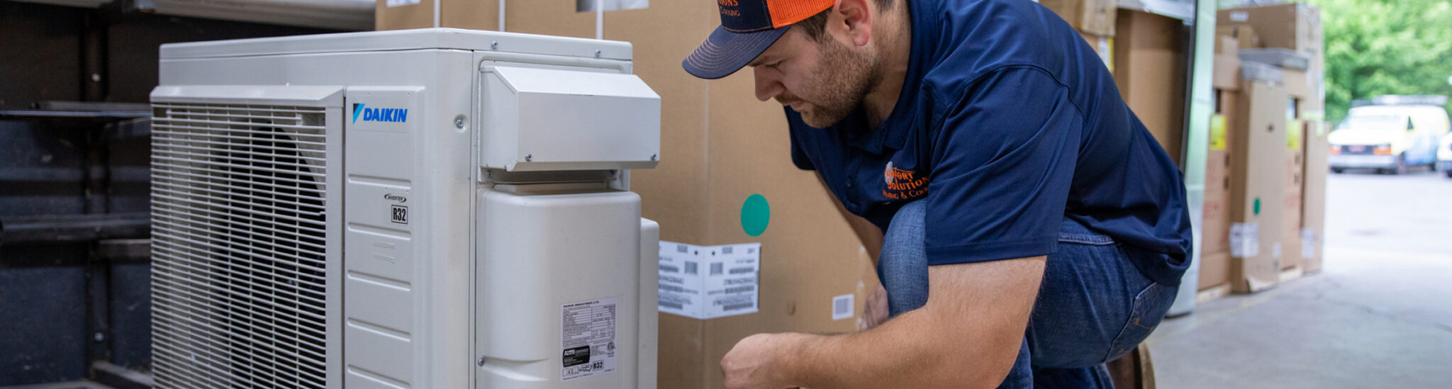 HVAC service tech working on an AC unit.