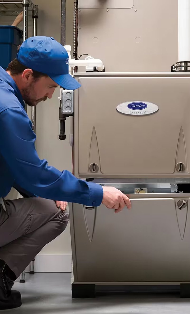 Comfort Solutions technician installing a replacement gas furnace.