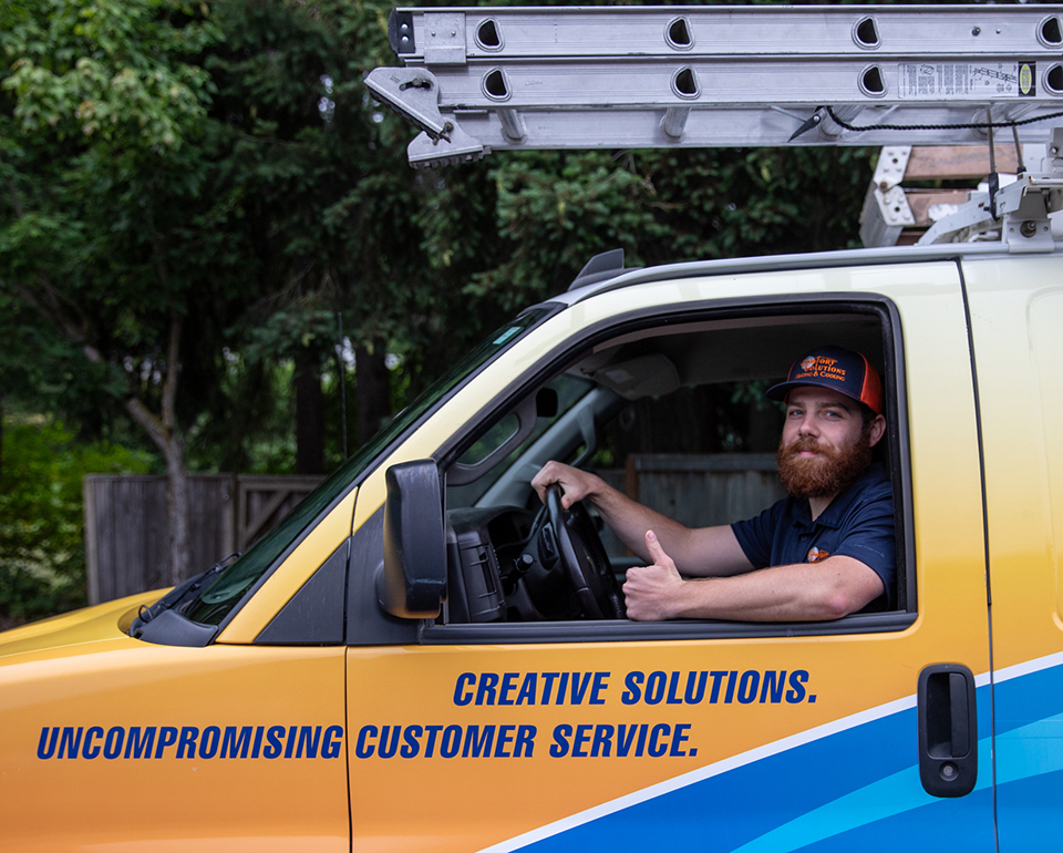 Comfort Solutions technician driving a branded service van